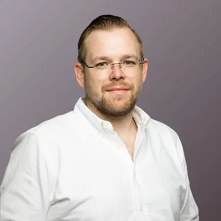 Chase Farmer, CTO and co-founder of Monarch Game Studios, in glasses and a white shirt